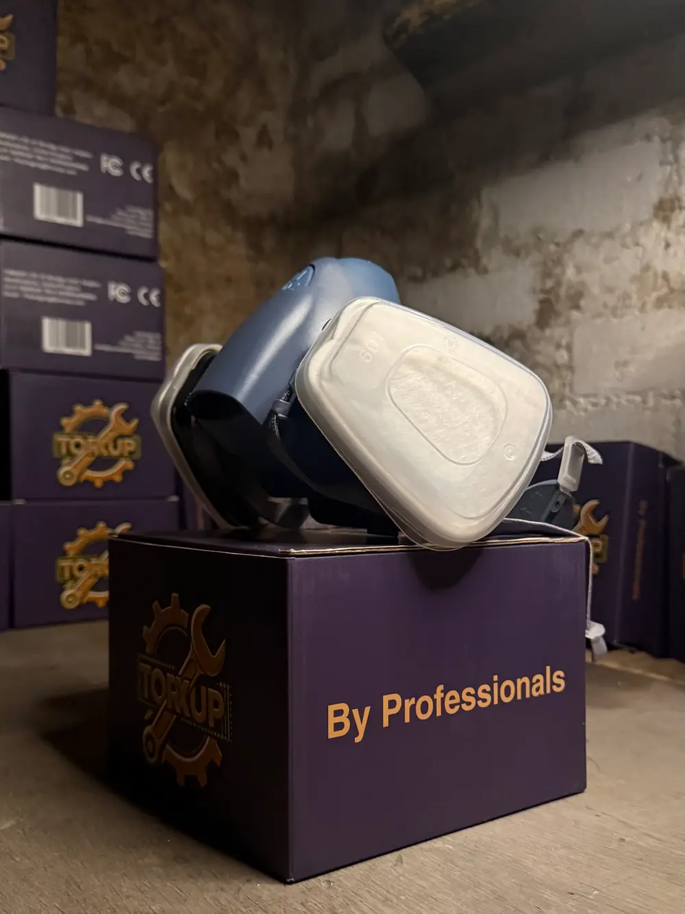 Torxup CoreMask on an angled box printed “By Professionals”, stacked boxes behind.