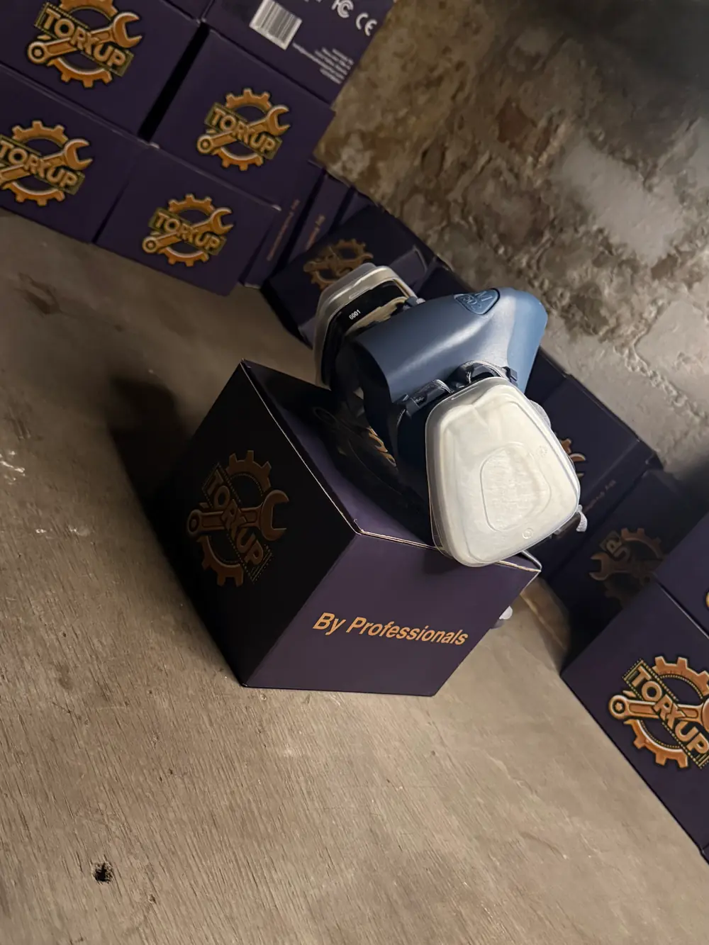 Torxup CoreMask on a tilted box among stacked Torxup boxes.